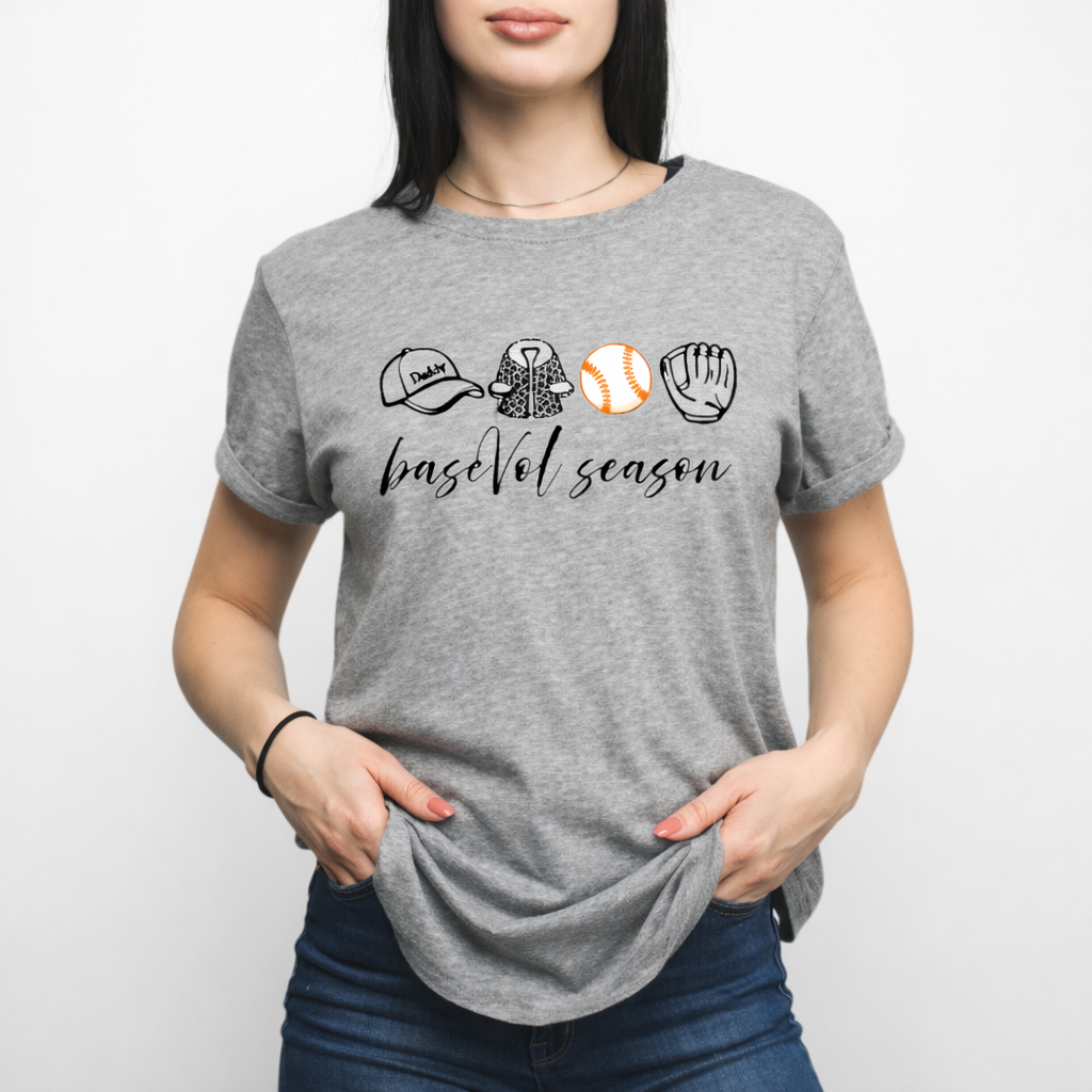 Gray tshirt with the words "baseVol" season on it and a daddy hat, fur coat, baseball, and glove